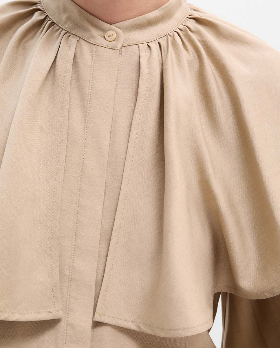 Blusa capa manga abullonada