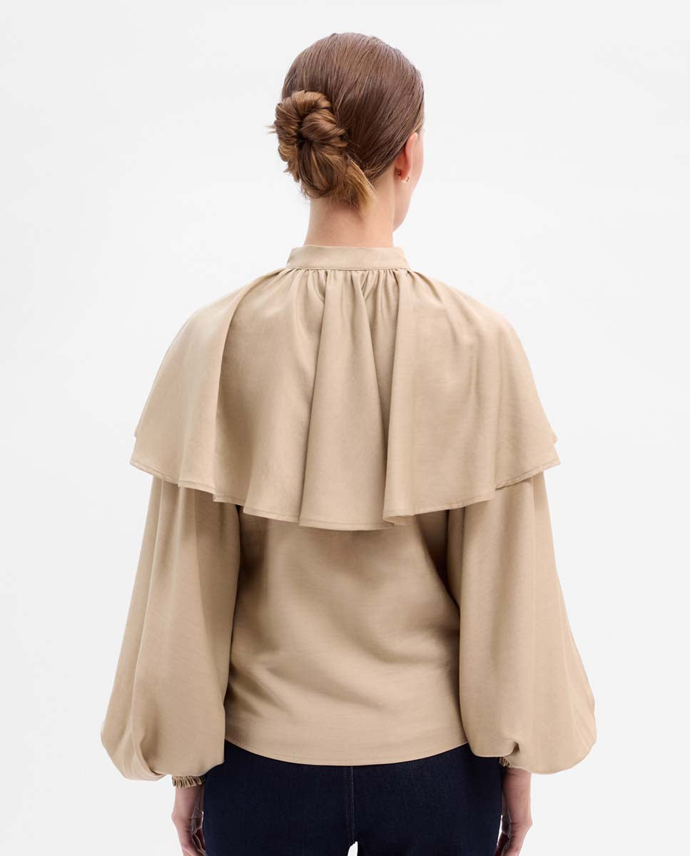 Blusa capa manga abullonada