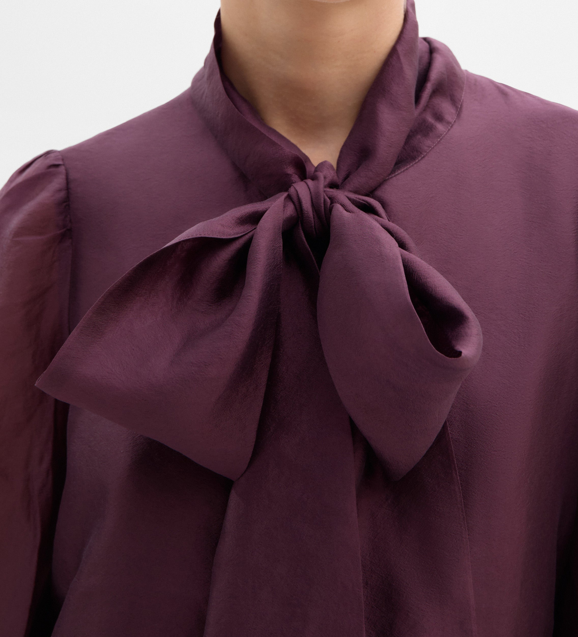 Blouse with a bow neck
